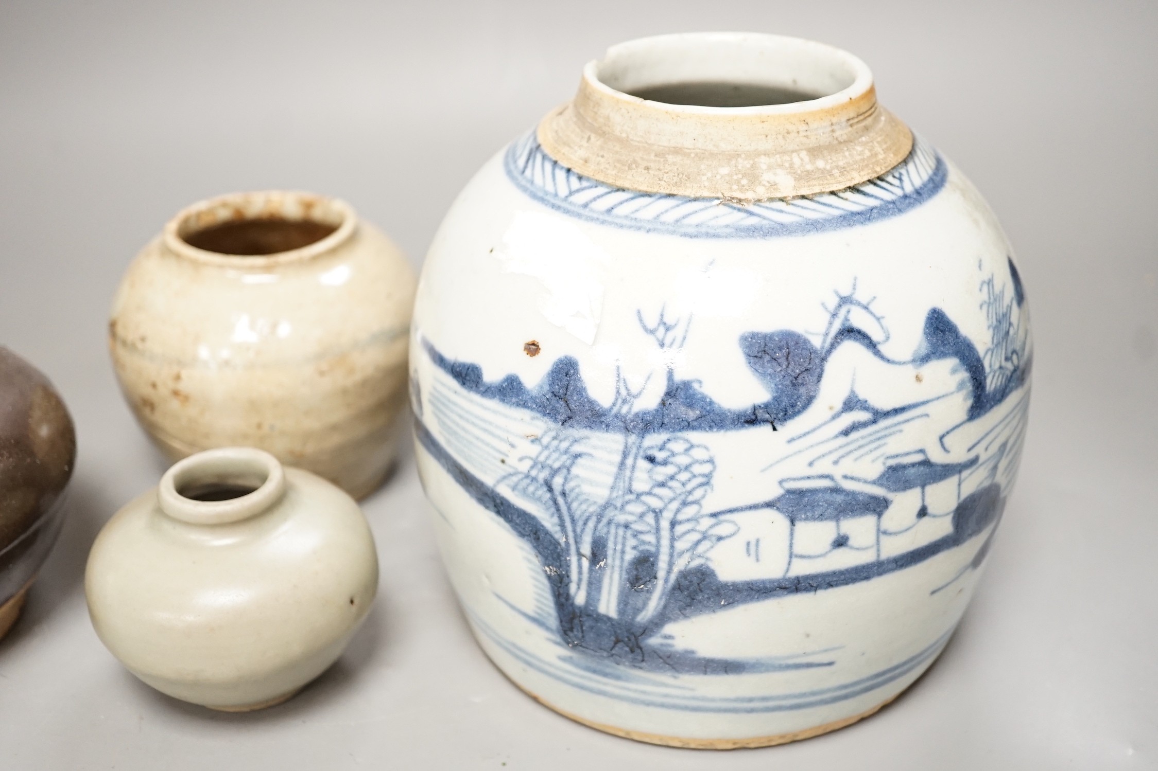A Chinese celadon jarlet, Yuan-Ming Dynasty, two provincial stoneware jars and a 19th century Chinese provincial blue and white jar, tallest 16cm